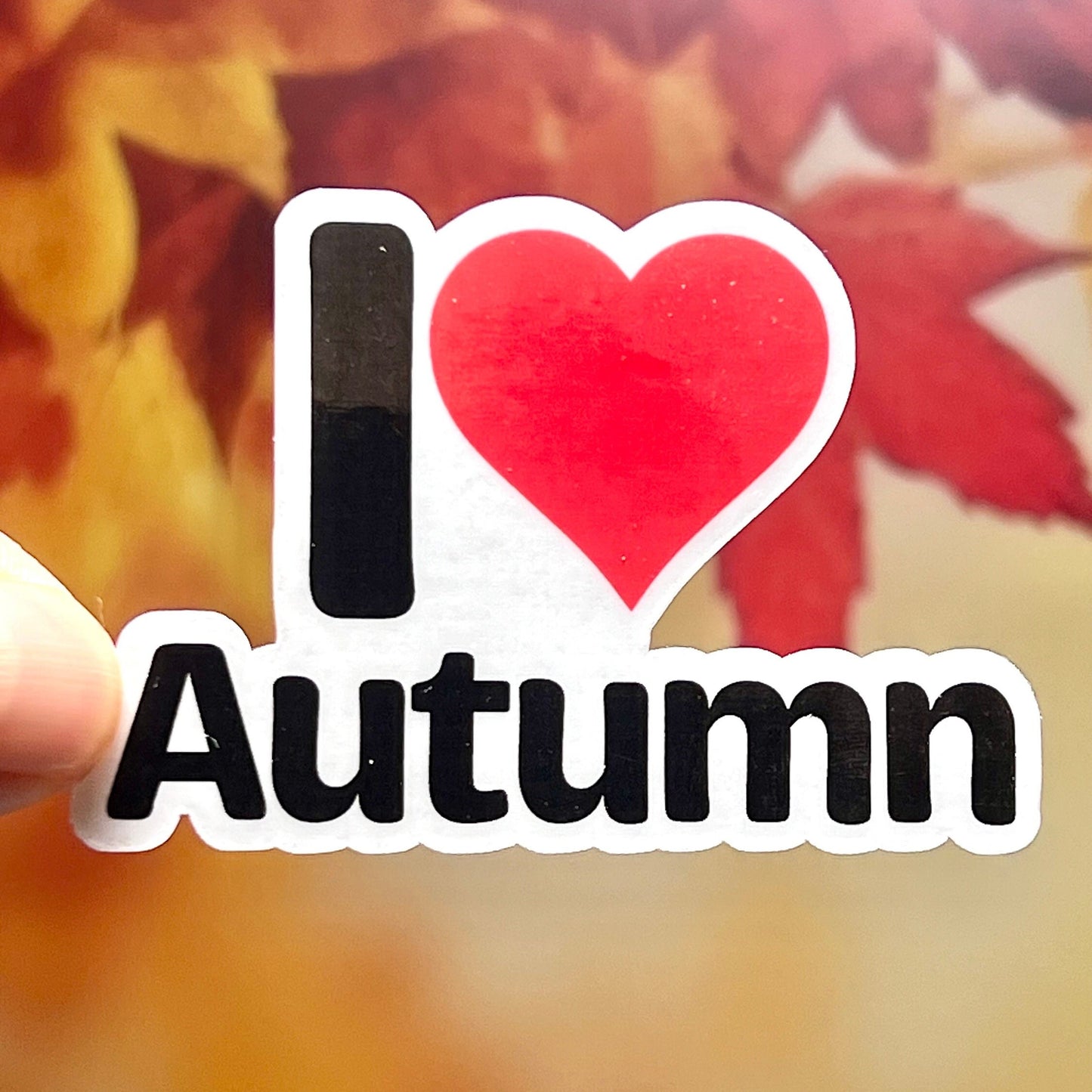 Sticker that says I love Autumn with a red heart instead of the word love.