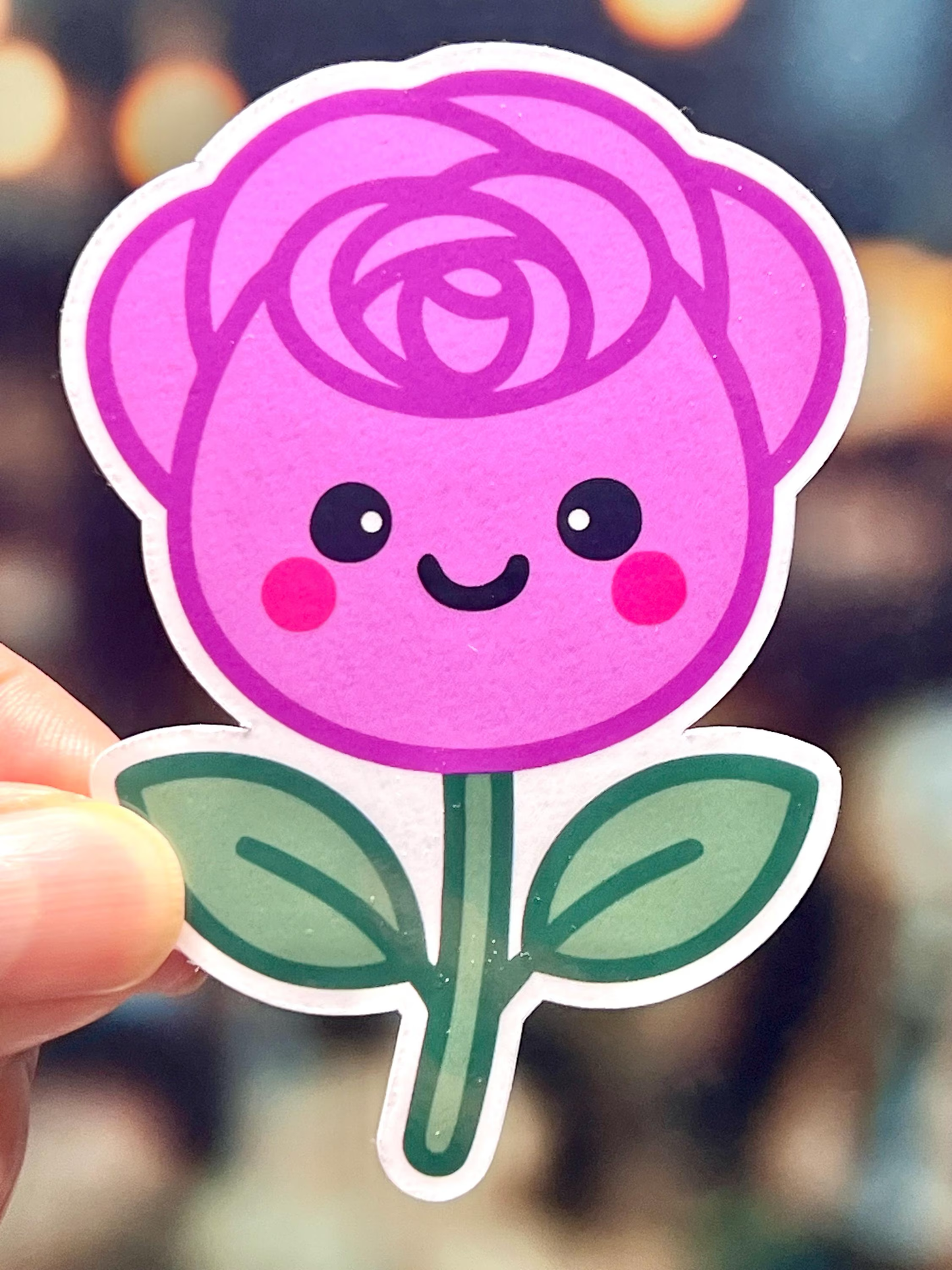 Sticker of a pink rose with a smiling face, kawaii design.