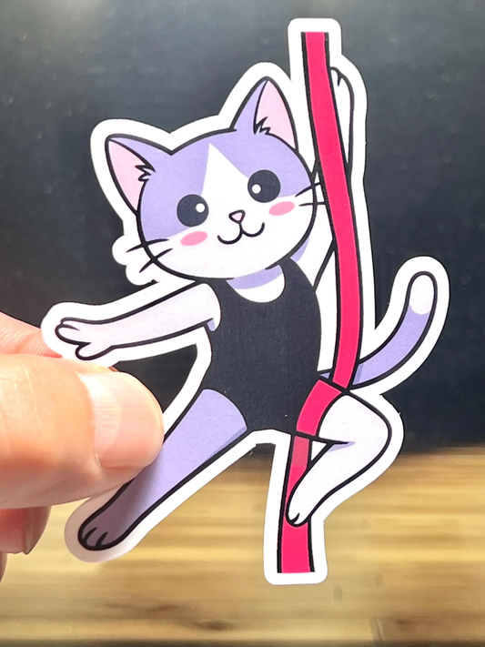Sticker of a a cat performing on aerial silks.