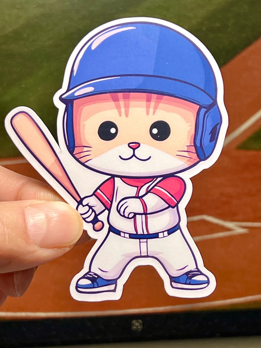 A sticker of a cartoon cat wearing a baseball uniform and a blue helmet, holding a baseball bat.