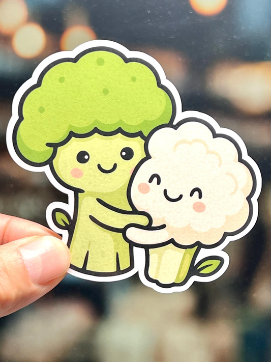 Cartoon sticker of a broccoli and cauliflower holding hands
