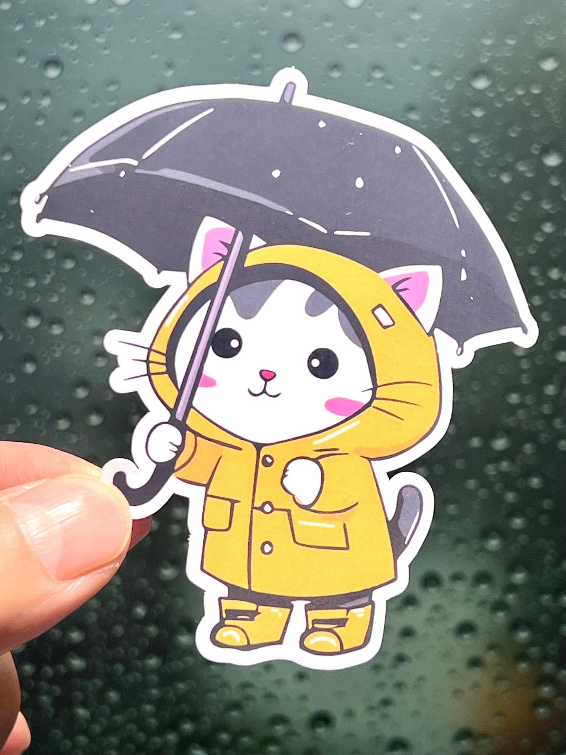 Sticker of a cat wearing a rain coat and carrying a black umbrella like the Morton's salt girl