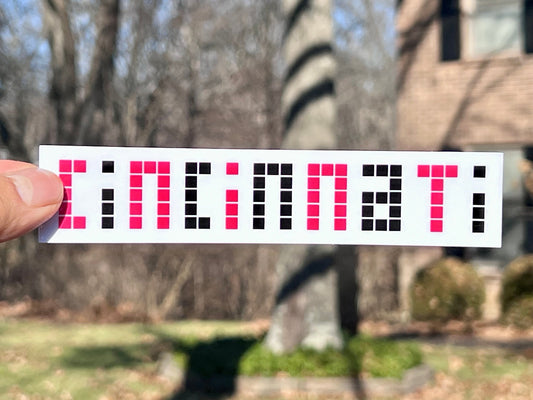 vinyl sticker with the word 'Cincinnati' written in red and black pixels on a white background