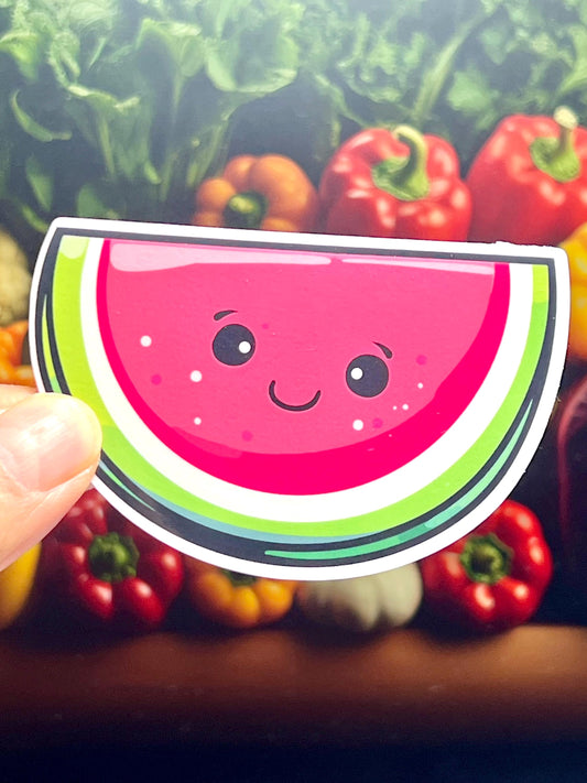 A sticker depicting a smiling, sliced watermelon in kawaii design