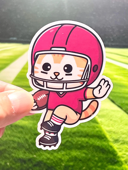 Sticker of cute cartoon cat in a football uniform holding a football throwing a stiff arm