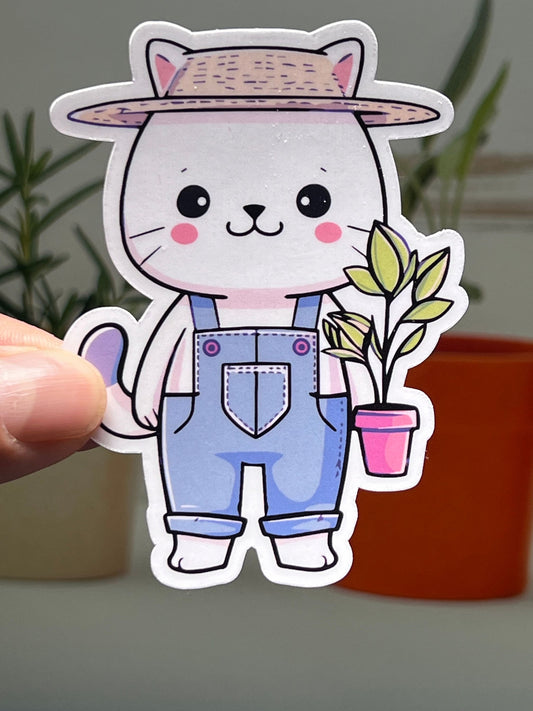 A vinyl sticker of a cartoon cat wearing a hat and overalls, holding a potted plant, designed for use on various surfaces.