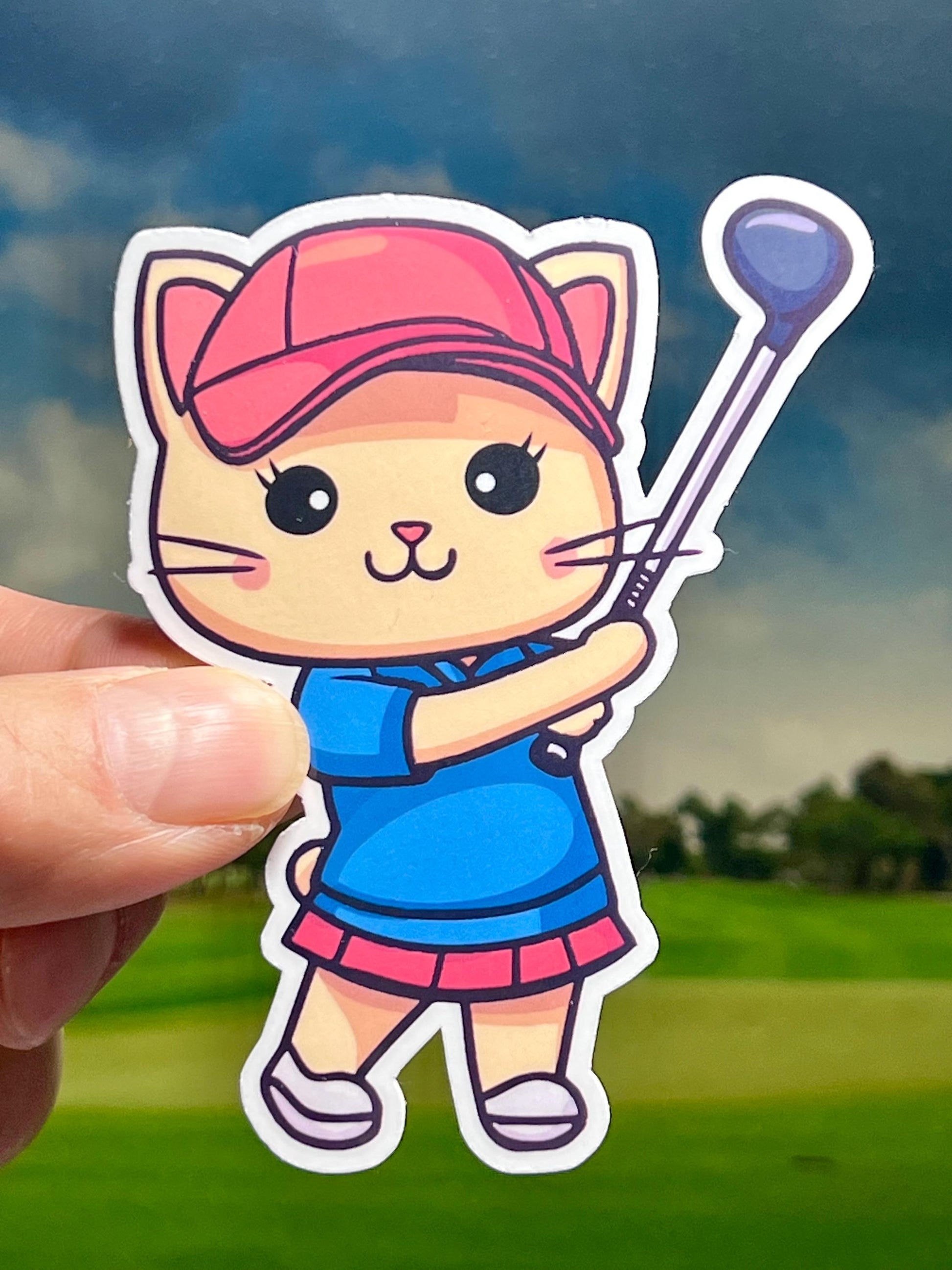 A vinyl sticker of a cute cat wearing a golf outfit and holding a golf club, posed as if playing golf.