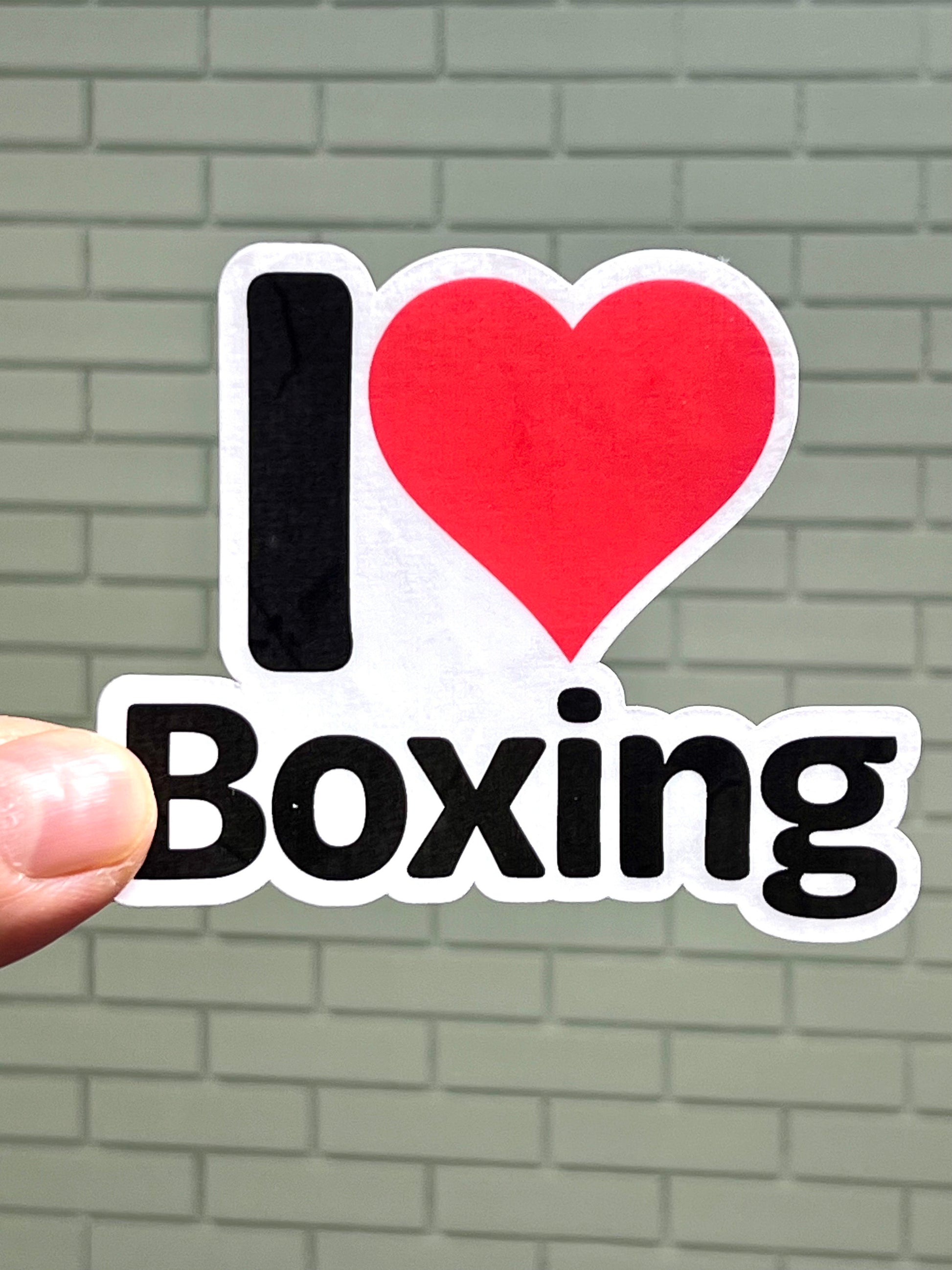 A vinyl sticker with the text 'I LOVE BOXING' and a heart symbol representing the word 'love'.