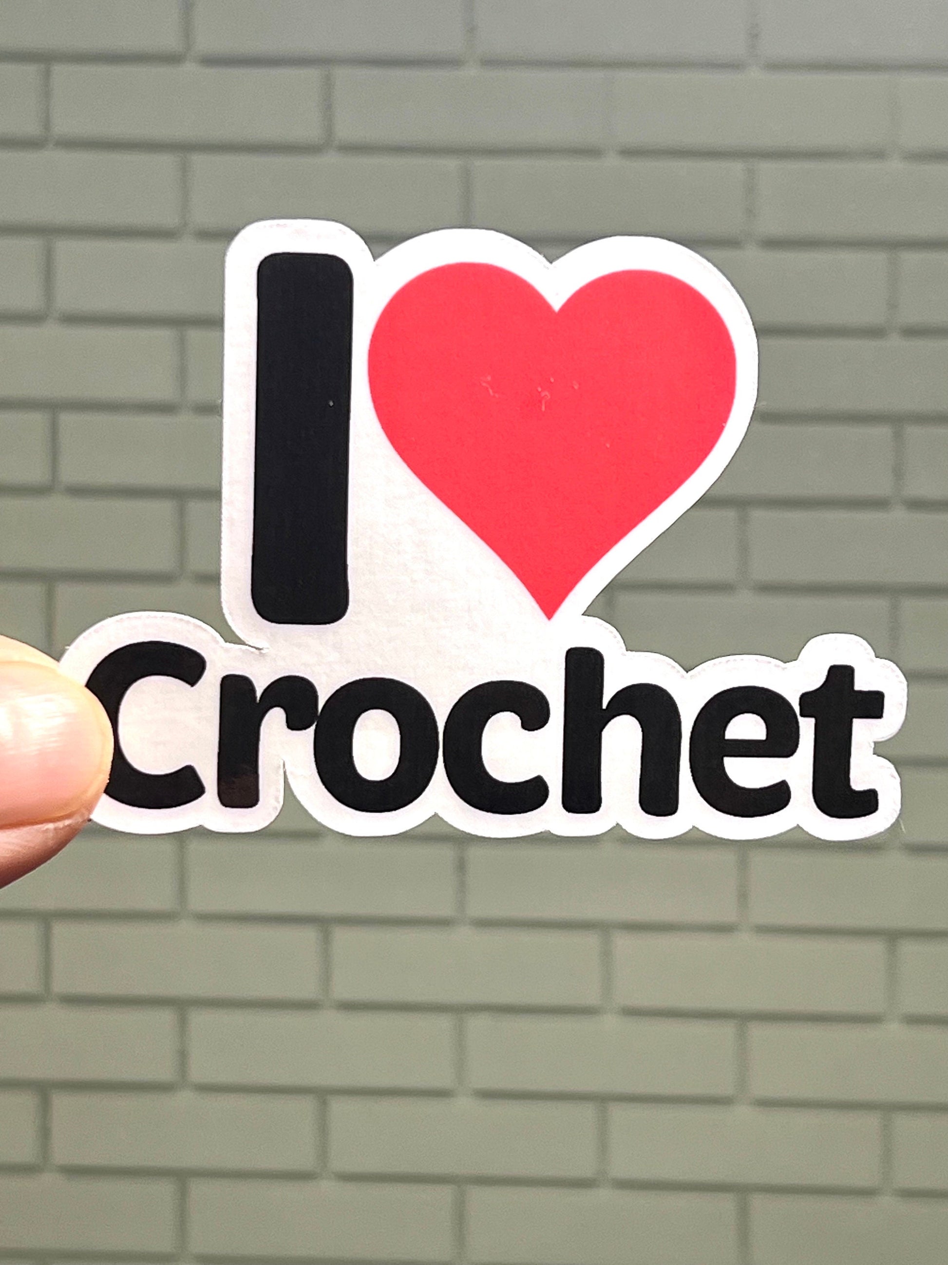A vinyl sticker with the text 'I love CROCHET' and a heart symbol