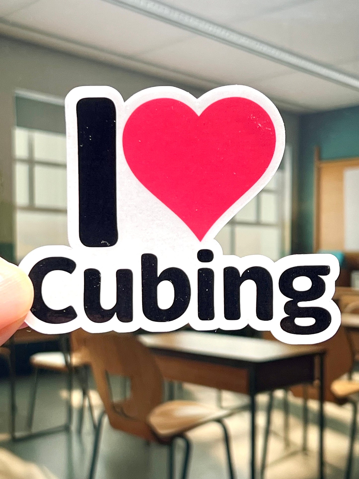 A vinyl sticker with the text 'I love CUBING' and a heart symbol. For those who like solving Rubik's Cubes