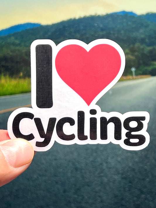 A vinyl sticker with the text 'I heart cycling' and 'cycling' with a red heart symbol replacing the word 'love'. 