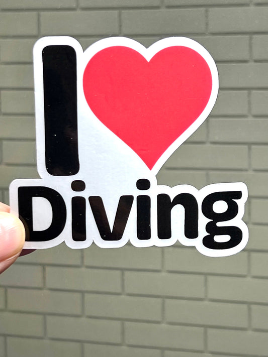 A sticker with the text 'I LOVE DIVING' and a heart symbol representing the word 'love'. The sticker is primarily red with a black 'I' and 'Diving' text.