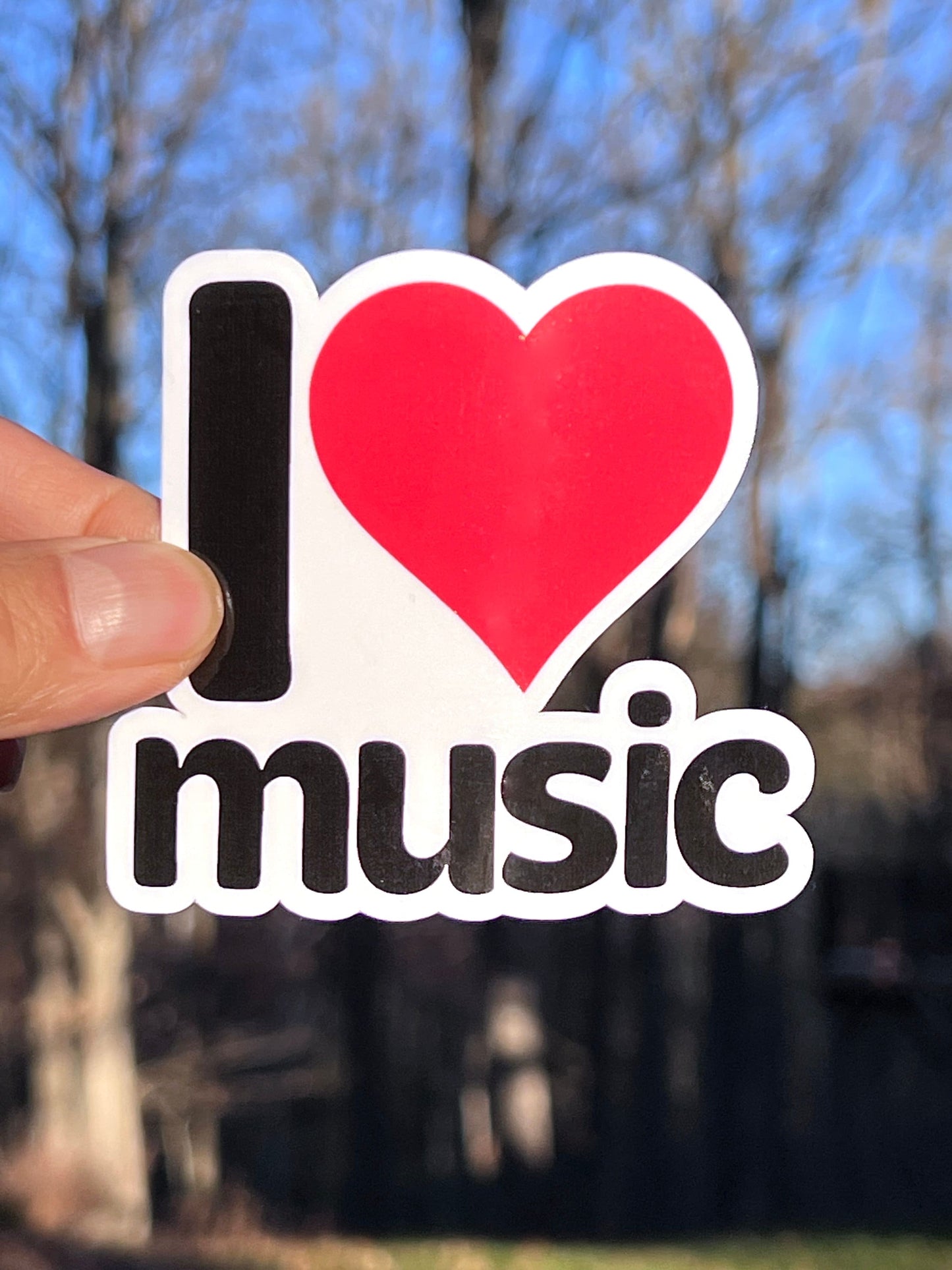A sticker with the text 'I LOVE MUSIC' and a red heart symbol
