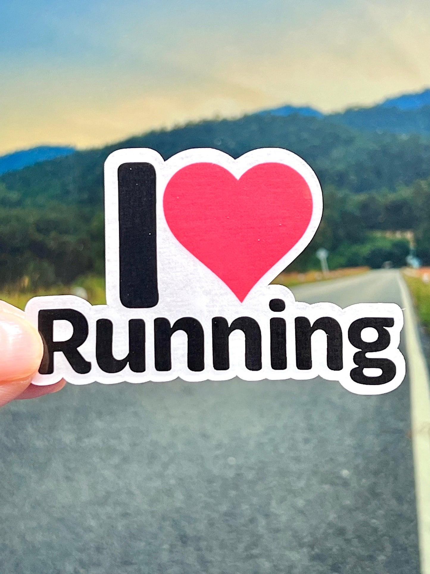 A vinyl sticker with the text 'I LOVE RUNNING' and a heart symbol