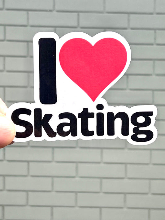 A vinyl sticker with the text 'I LOVE SKATING' and a red heart symbol representing the word 'love'. The sticker is black with red and white text.