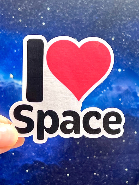 A sticker with the text 'I LOVE SPACE' and a heart symbol