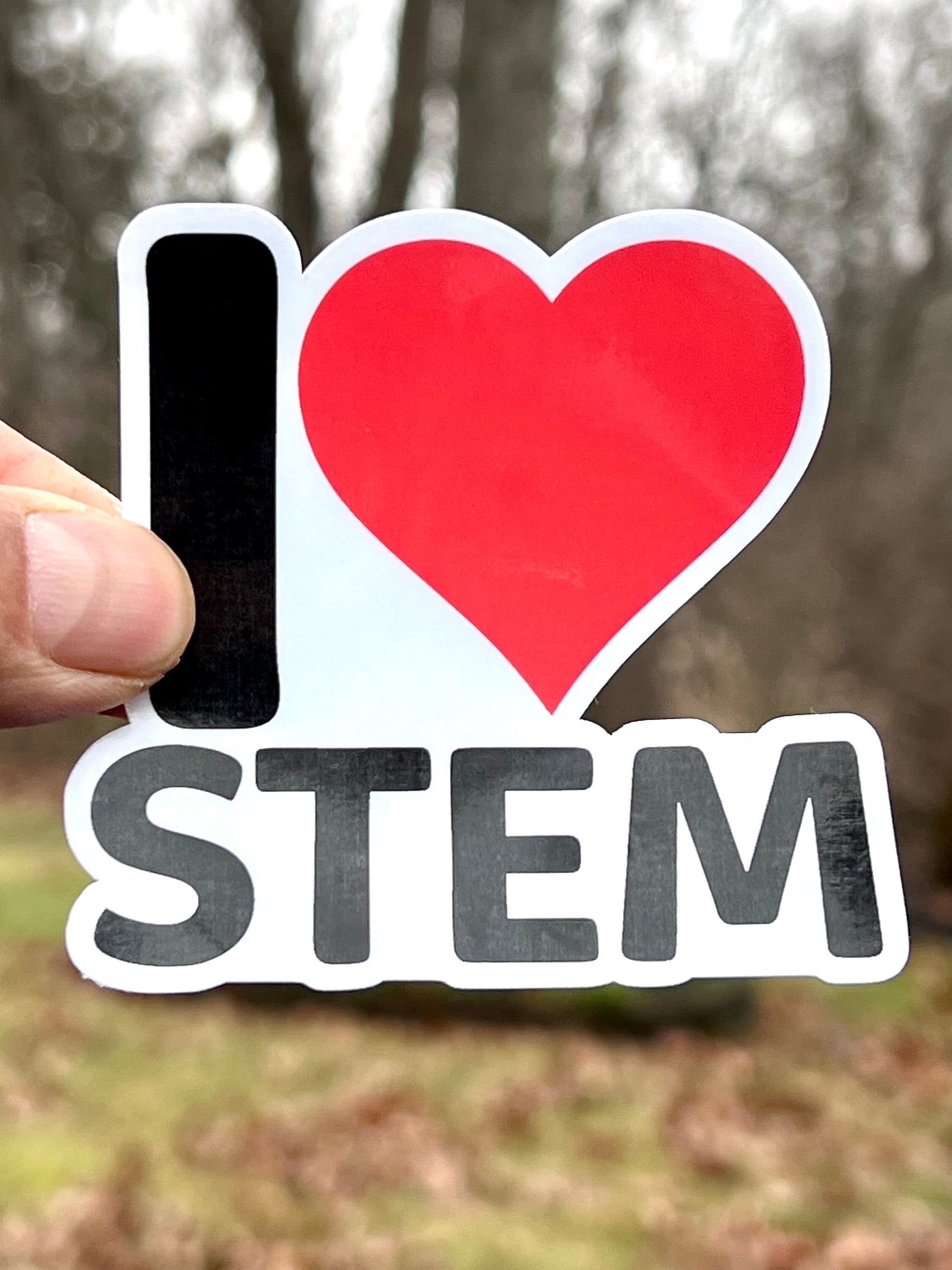 A vinyl sticker with the text 'I Love STEM' and a heart symbol.