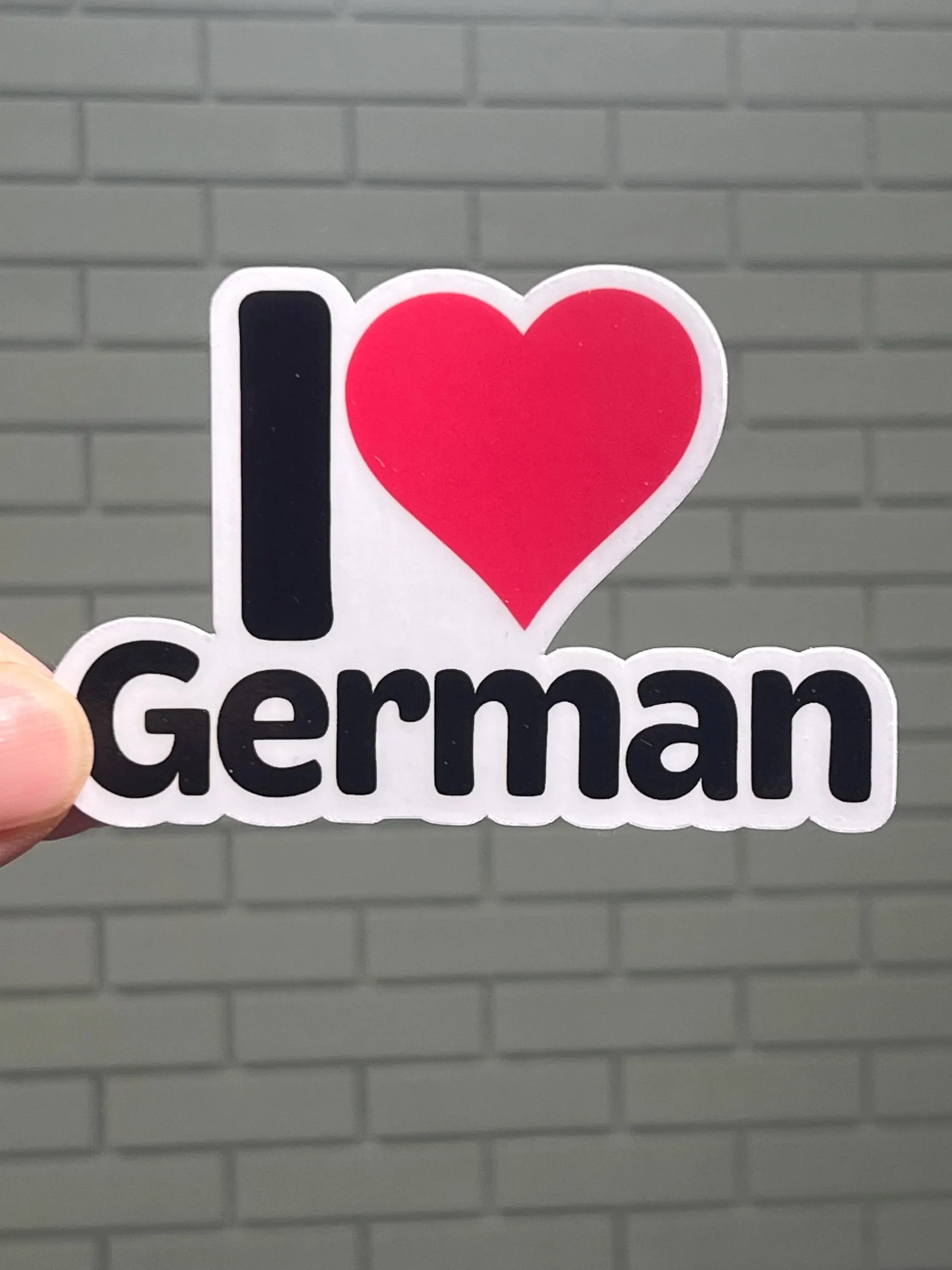 A vinyl sticker with the text 'I love German' and a heart symbol