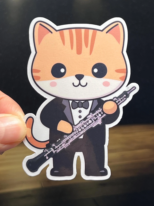 A vinyl sticker of a cartoon cat oboist wearing a tuxedo and holding an oboe. 