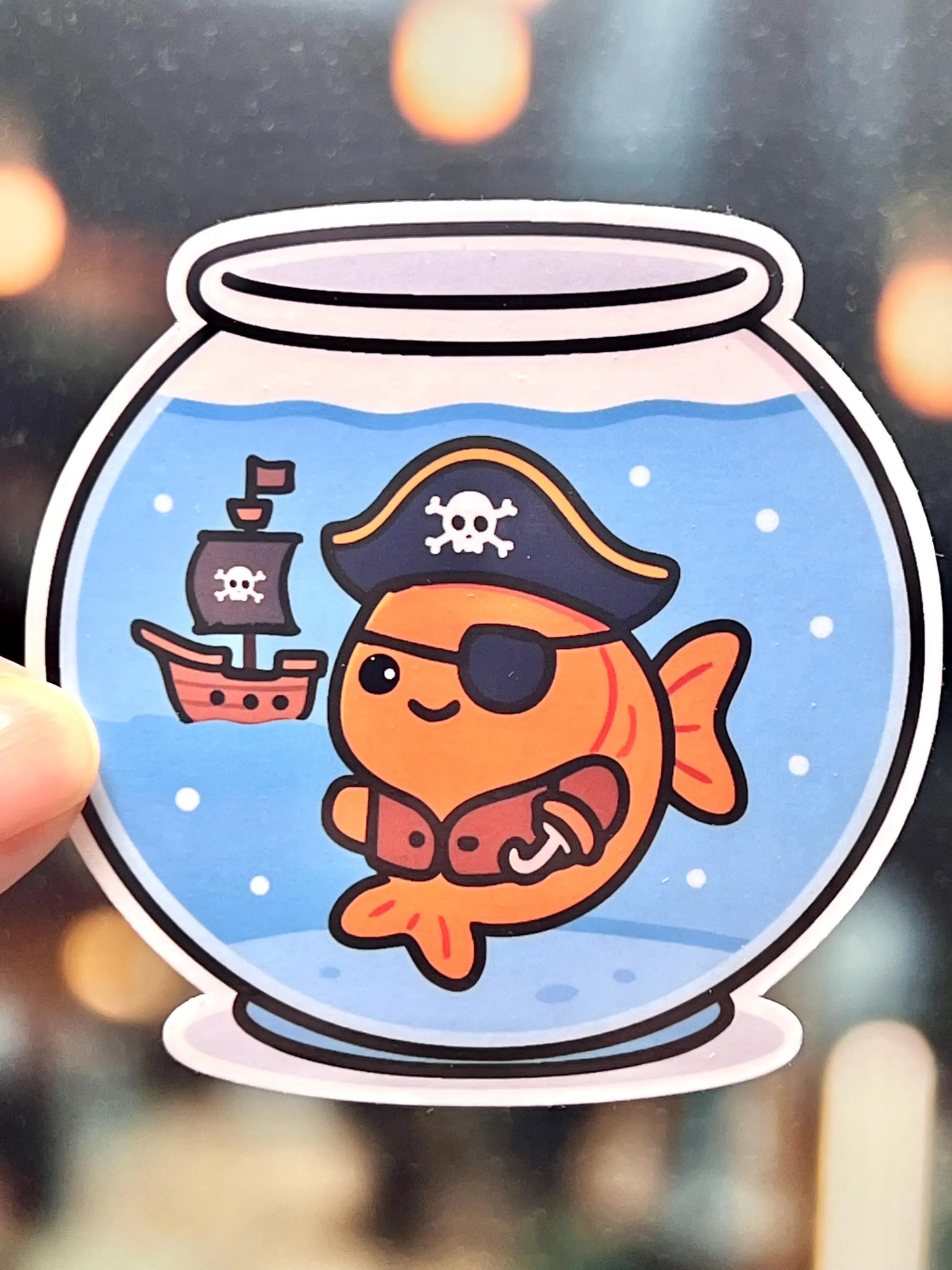 Sticker of a pirate-themed fish in a fish bowl 