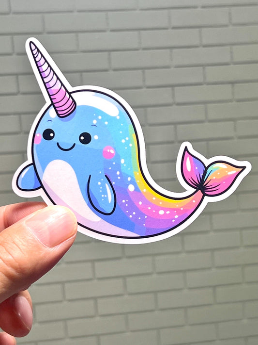 A sticker of a multicolored  narwhal whale, with a happy facial expression