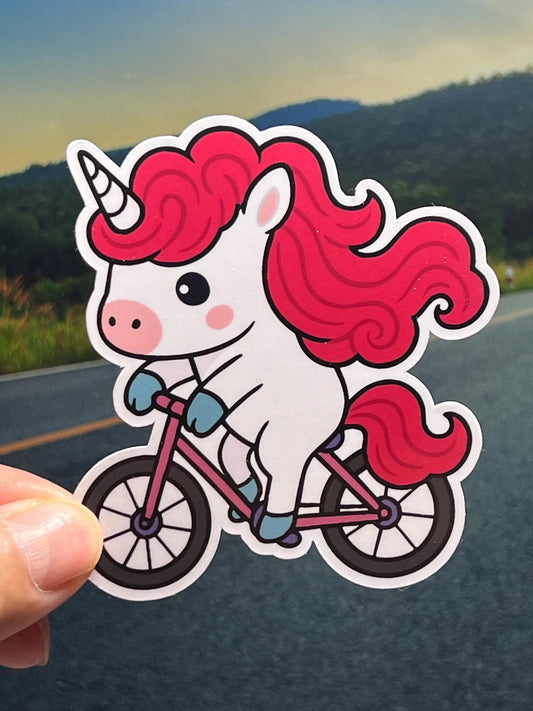 Cartoon unicorn riding a bike with red hair vinyl sticker
