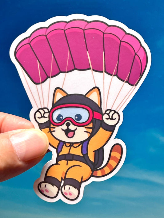 Sticker of a kawaii design cat with a pink parachute