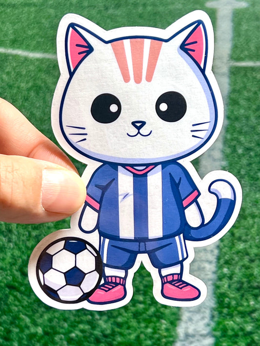 Sticker of a cat in a soccer uniform with a soccer ball at its feet