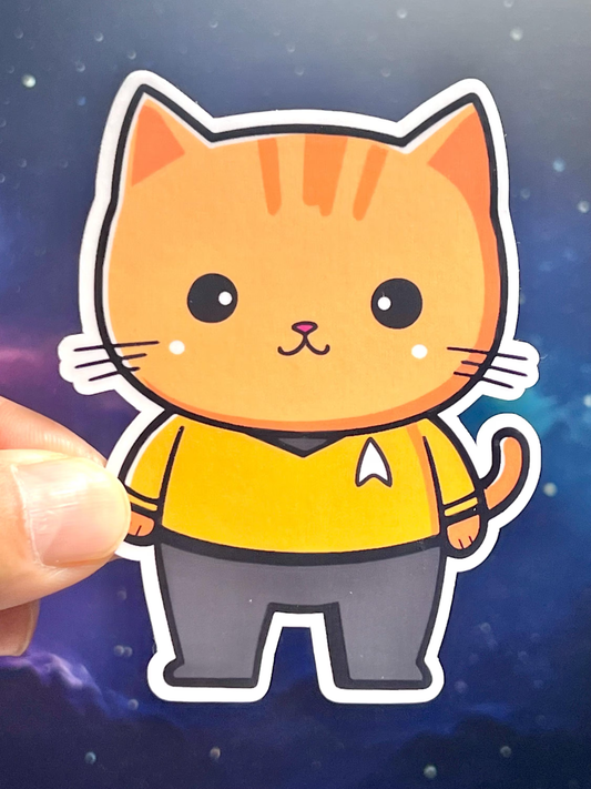 A sticker of a cartoon cat wearing a Star Trek  yellow uniform shirt- Command or Captain