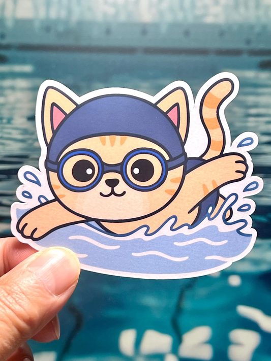 Sticker of a cartoon cat swimming with goggles and swim cap
