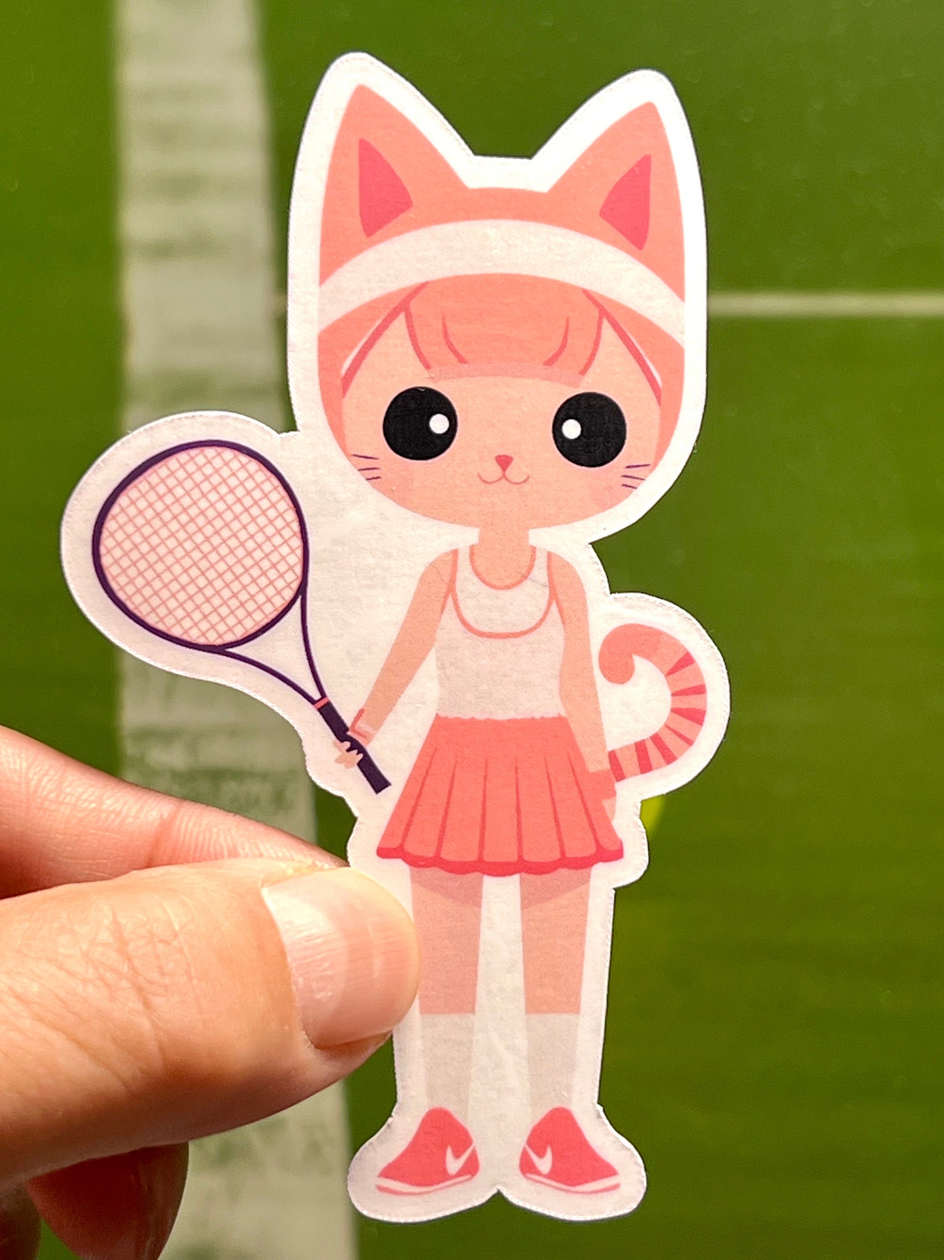 A vinyl sticker of a cartoon-style female cat wearing a tennis outfit and holding a tennis racket.