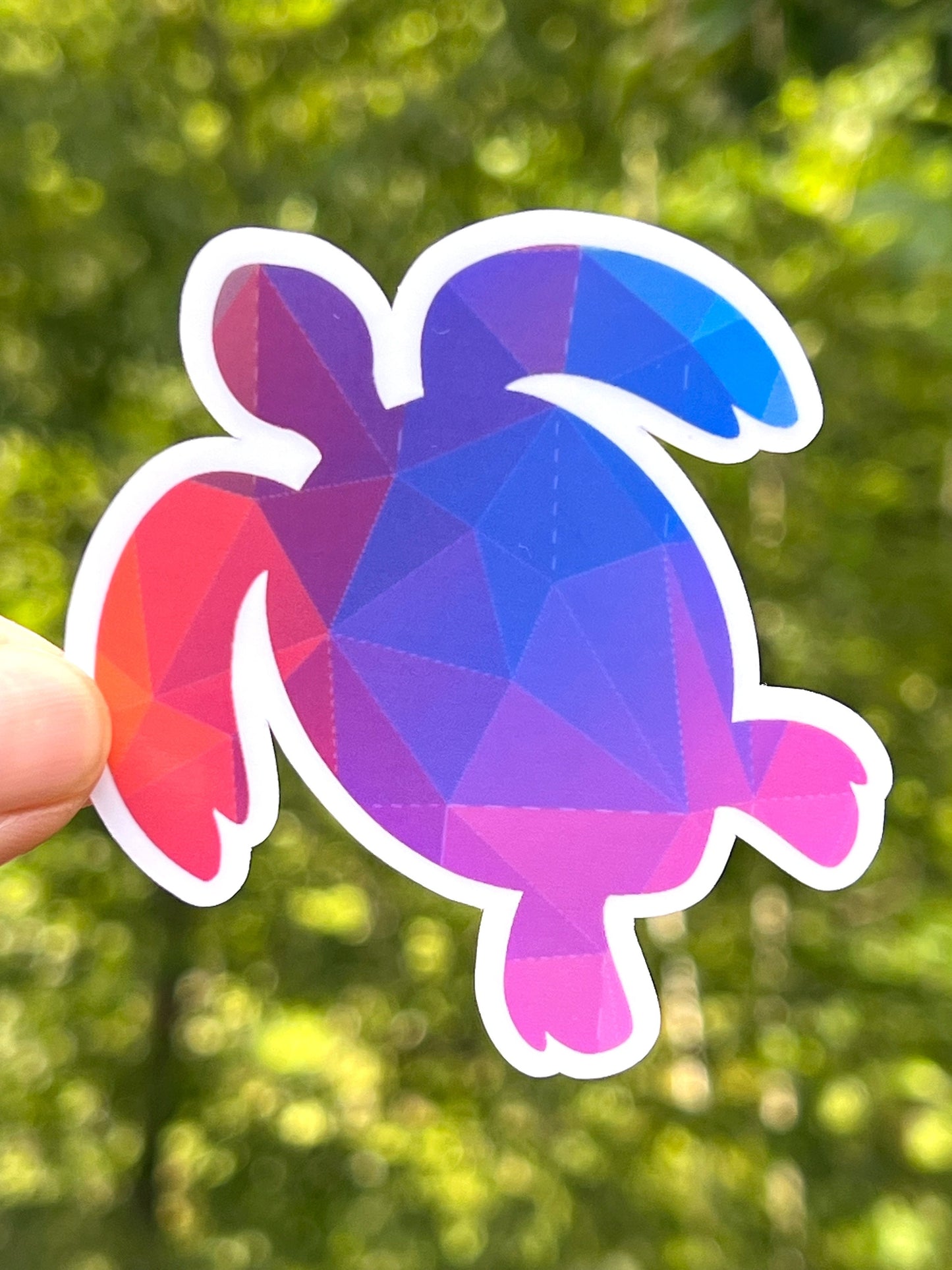A sticker that is a simple turtle shape with geometric patterns on it. Blue and purple color