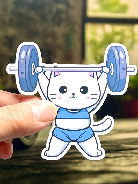 A vinyl sticker of a cartoon cat lifting a barbell locked out overhead.
