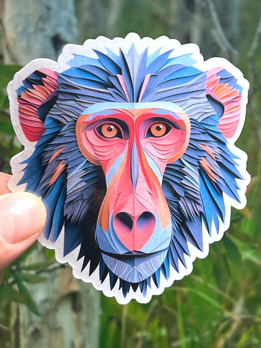 A colorful vinyl sticker of a stylized baboon head