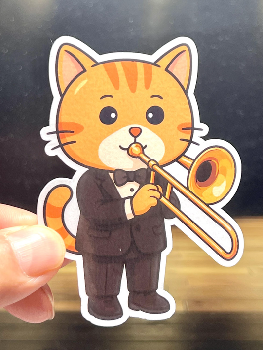 Sticker of a cat in a tuxedo playing a trombone held by a hand.