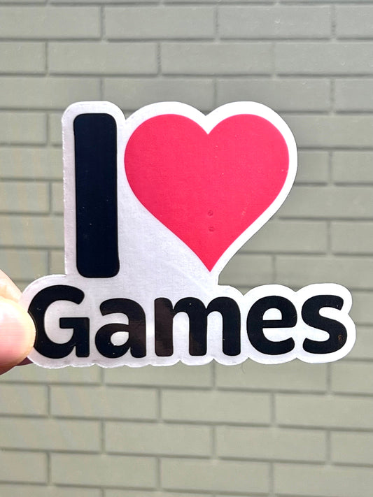 A vinyl sticker with the text 'I LOVE GAMES' and a red heart symbol between the words.